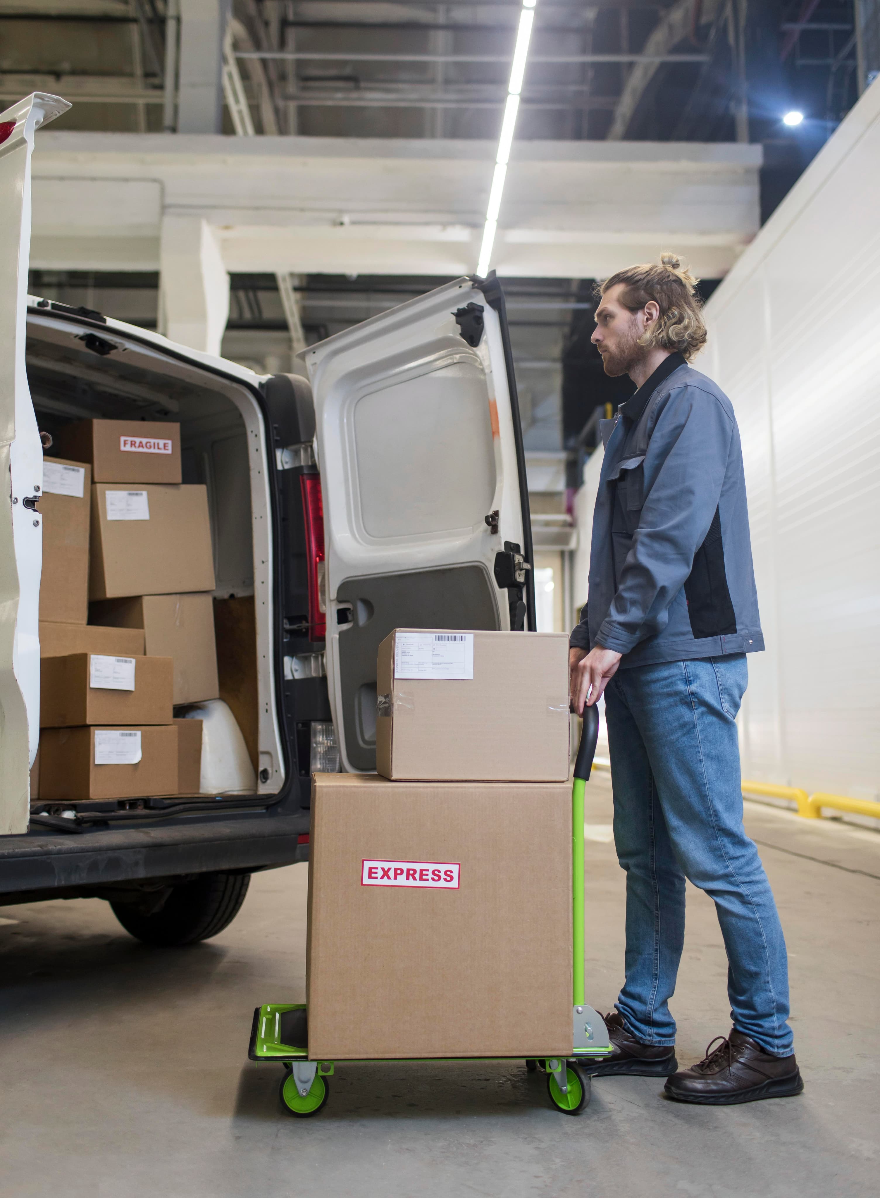 Professional driver loading delivery van